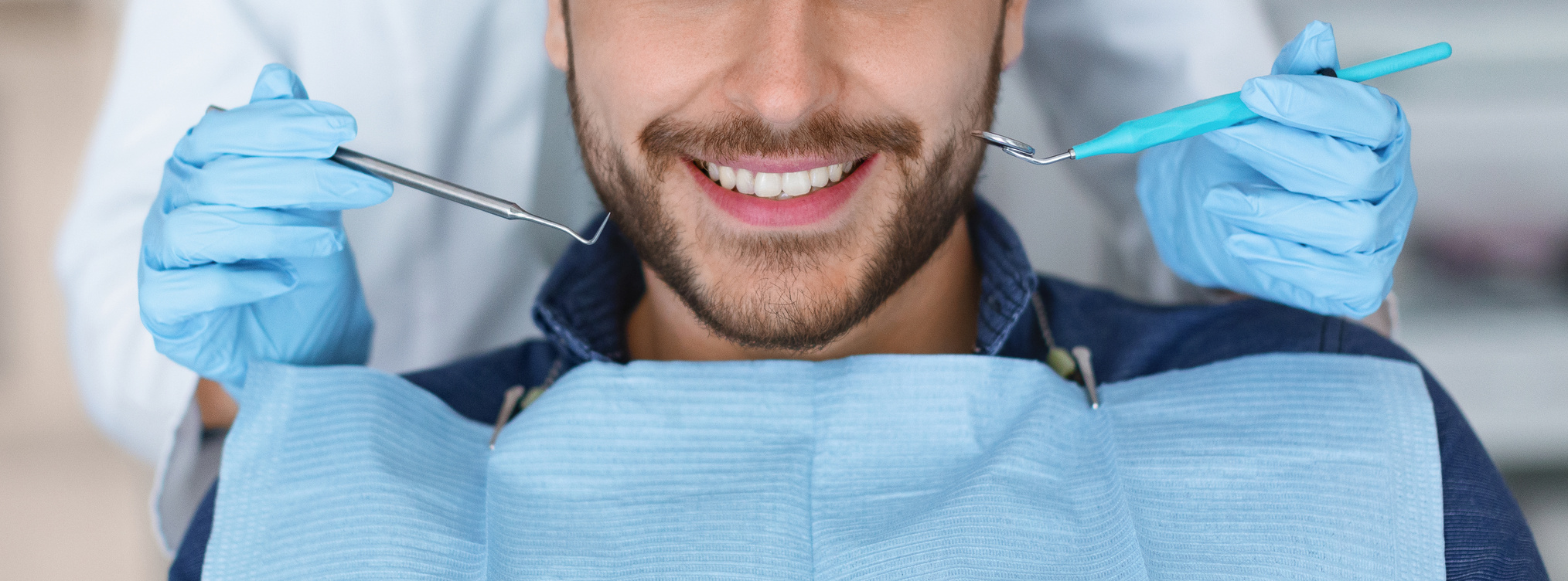 Cropped of Smiling Man and Dentist Hands with Tools, Panorama